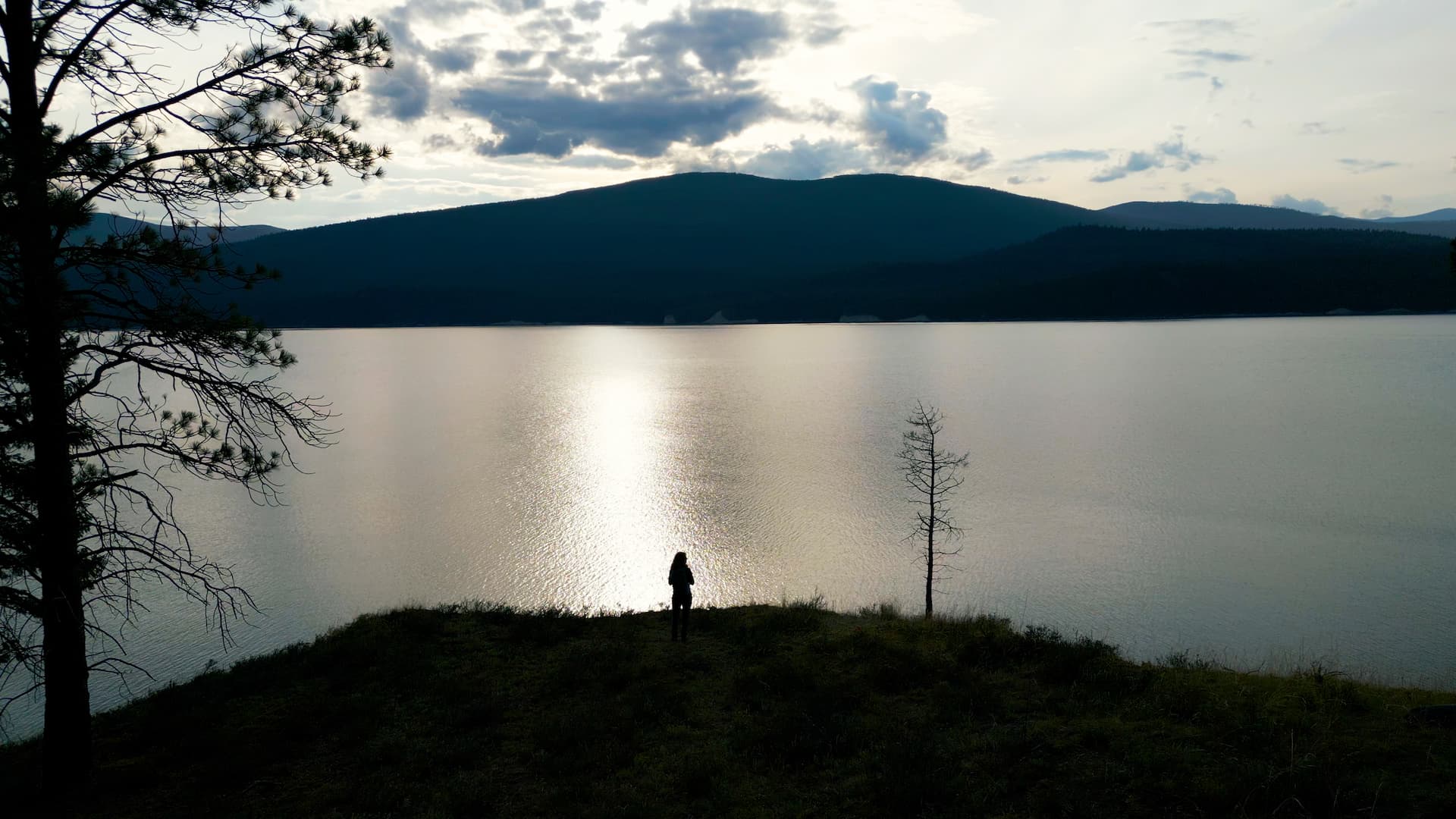 Peaceful Montana lake at dusk with mountains in the background
