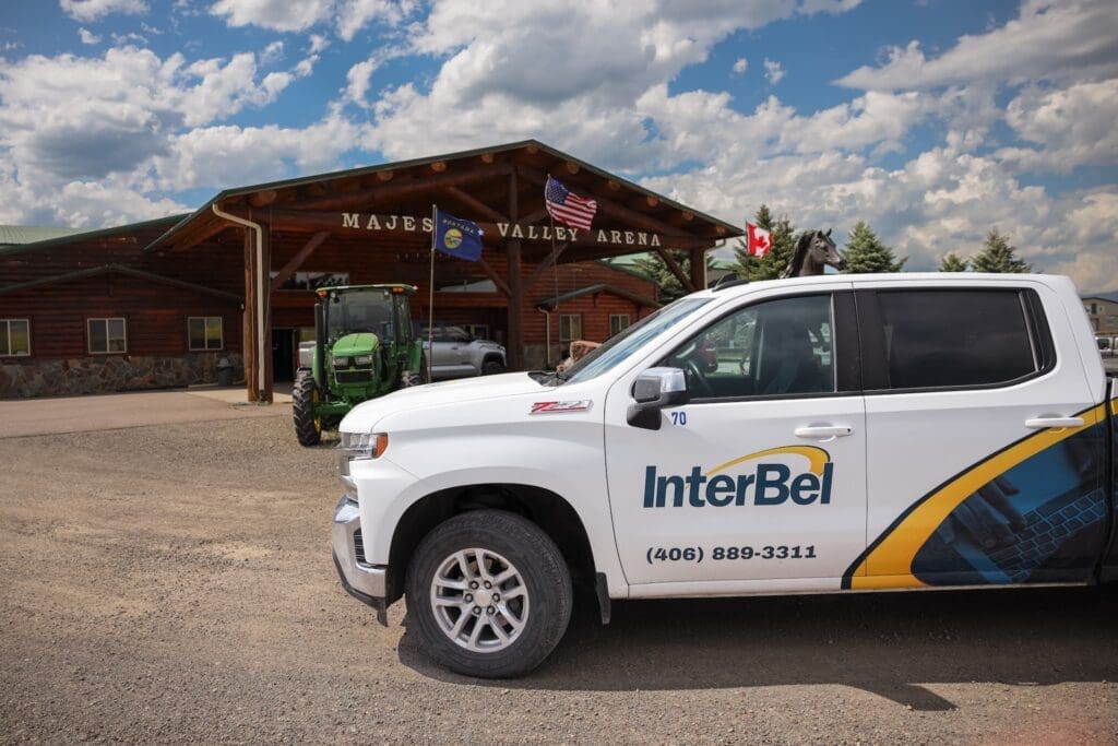 White InterBel truck parked in front of Majestic Valley Arena in Montana