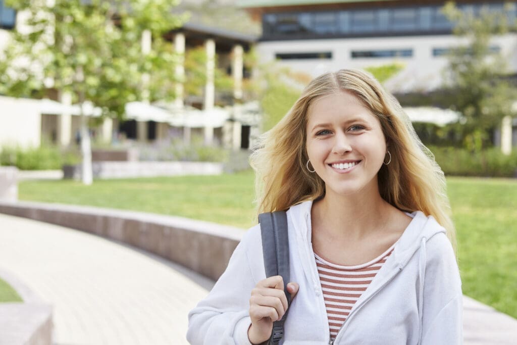 Female student walking along a campus pathway, highlighting InterBel college scholarship opportunities